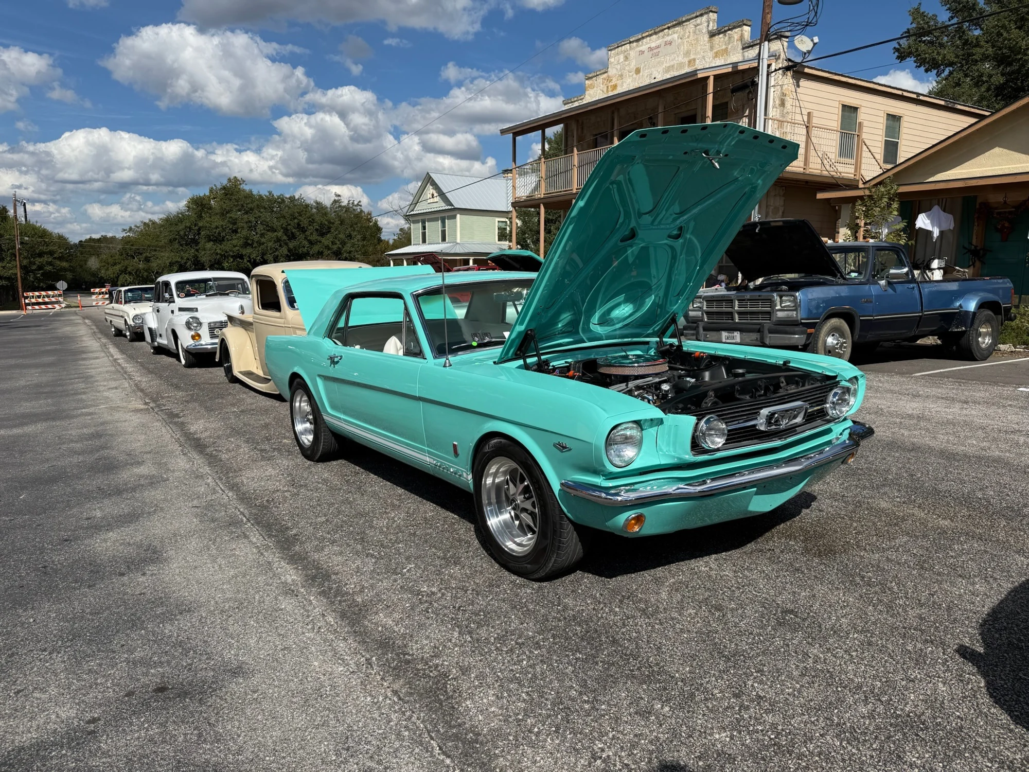 Vivian at a car show, with her turquoise hood raised